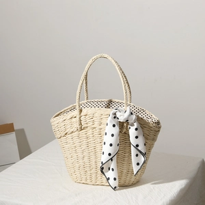 Straw woven tote bag with polka dot scarf detail for summer beach vacation style
