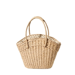 Straw woven handbag with polka dot lining for summer beach vacations in natural beige
