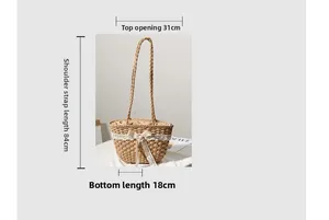 Detail of straw tote bag with white lace bow showing the 31cm top opening width