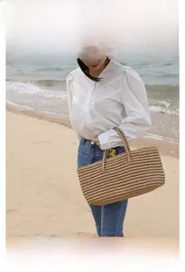 Close-up of a large capacity straw woven tote bag with natural beach vacation styling