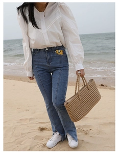 Close-up of a large handmade woven straw tote bag for beach vacations and summer style
