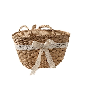 Natural straw woven handbag with white lace bow decoration and interior lining