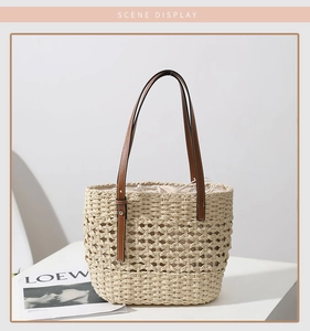 Close-up of woven straw tote texture with leather handles and drawstring inner bag