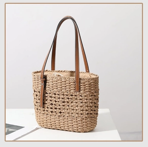 Detailed view of hand-woven straw tote with hollow mesh pattern and drawstring liner