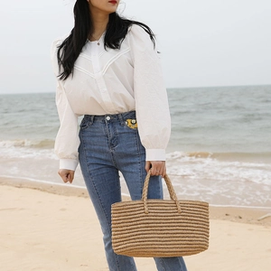 Handmade woven straw tote bag for beach vacations with large capacity and thick handles