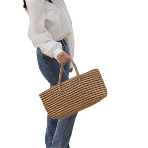 Handwoven straw tote bag for women with round handles for beach vacations and seaside trips