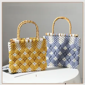 Detail of handmade cotton woven bag featuring bamboo handles and yellow diamond patterns