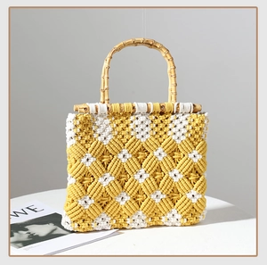 Detailed macro view of yellow and white macrame woven pattern with natural bamboo handle