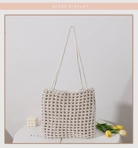 Detailed close-up of ivory woven mesh tote bag with minimalist hollow knot pattern