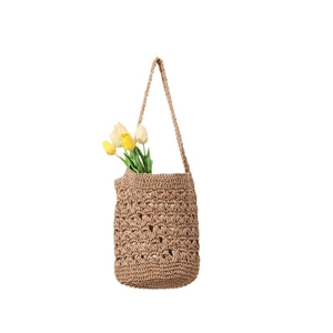 Handmade straw bucket bag with floral crochet patterns and fringe for beach vacations