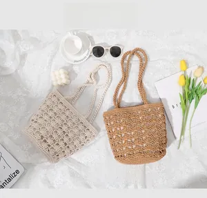 Detail of shell pattern crochet handbag in beige and caramel on lace background