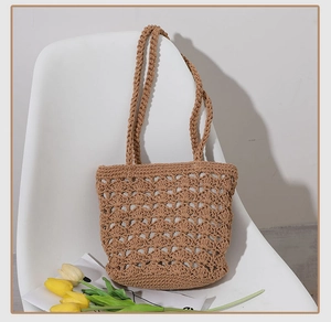Detail of hollow crochet texture and woven strap on earthy tone handmade beach bag