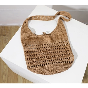 Hollow straw shoulder bag in camel brown for beach vacations and casual summer use
