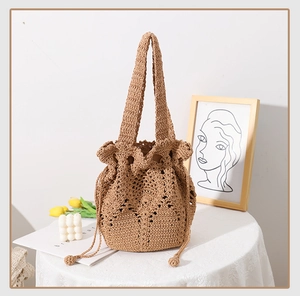 Detail of hand-woven beige cotton rope bucket bag with floral crochet hollow pattern