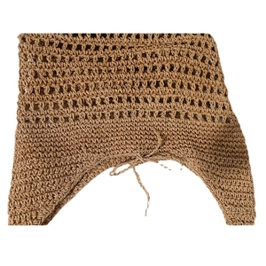 Brown hollow crochet straw bag for beach vacation with drawstring and woven details