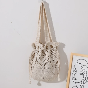Handmade crochet bucket bag with hollow floral pattern and drawstring in beige