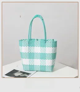 Detail shot of mint green and white checkered woven tote bag made of eco-friendly PP material