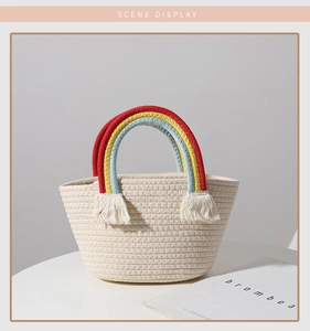 Detail of hand-woven beige cotton bag with colorful rainbow handle and fringe accents