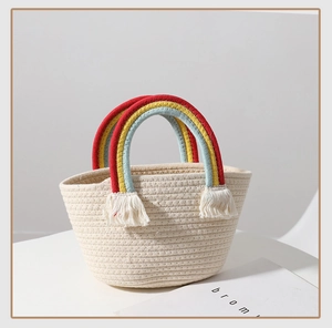 Detail of woven tote bag featuring rainbow-colored handles and white tassel accents
