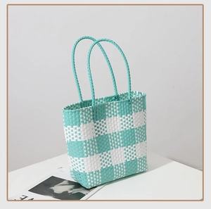Detail of mint green and white checkered woven tote bag with sturdy double handles