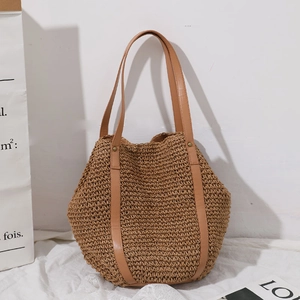 Handwoven straw tote bag with brown faux leather handles for beach holidays