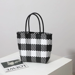 Fashionable black and white checkered woven straw tote bag for summer beach vacation