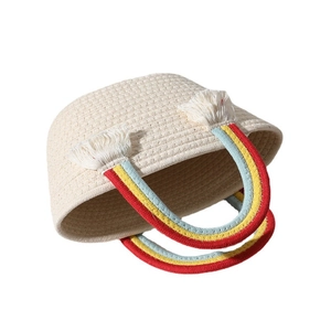 Handmade rainbow woven cotton tote bag with colorful handles and white tassels for beach trips