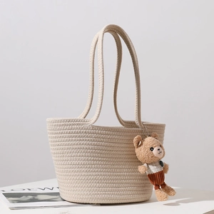 Handmade cream woven cotton tote bag with a cute bear plush charm for beach vacations