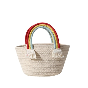 Handmade woven cotton tote bag with rainbow colored handles and decorative side tassels
