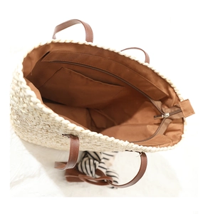 Vue de dessus du sac cabas en paille avec doublure interne et anse en cuir marron