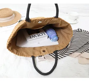 Detail of spacious straw tote interior with magnetic clasp and internal pocket view