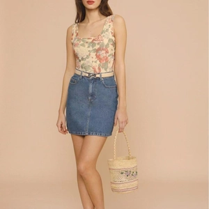 Raffia bucket bag with floral embroidery and casual vintage summer outfit