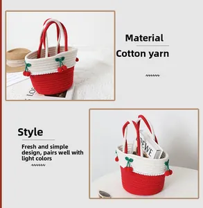 Detail of red and white woven cotton bag featuring handmade crochet cherry charms and handles