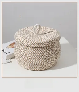 Detail of hand-woven cotton rope storage basket featuring beige grid texture and lid