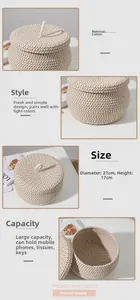 Detail of round cotton rope storage basket with lid showing texture and top handle