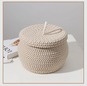 Detailed close-up of a handmade cotton rope storage basket with lid and white ring handle