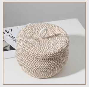 Detail of round cotton rope storage basket featuring dual-tone weave and a secure lid