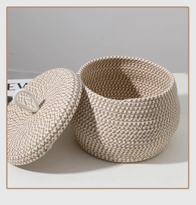 Macro view of woven houndstooth cotton rope storage bin with lid and ring handle