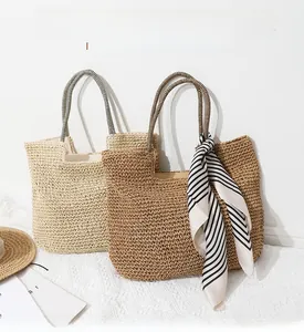 Close-up of woven straw tote bags with striped handles and ribbon decoration on floor