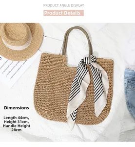 Detailed view of woven straw tote bag with size guide 44x31cm and summer styling