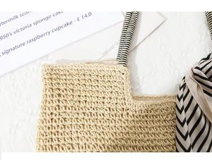 Close-up of handwoven straw bag featuring fine crochet texture and decorative ribbon