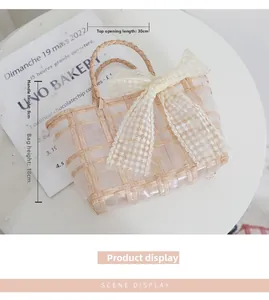 Detail of woven straw bag with white lace floral bow showing dimensions 30x18cm