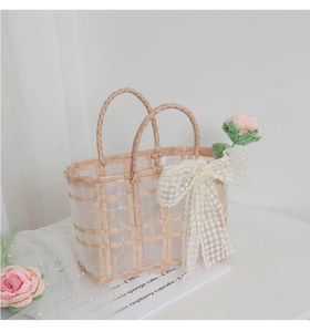 Detailed shot of pink crochet flower and lace bow on a transparent woven bridal gift bag