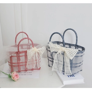 Pink and blue-grey woven hand baskets featuring elegant oversized lace bows
