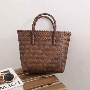 Vintage dark brown woven straw tote bag with dual handles for beach vacation style