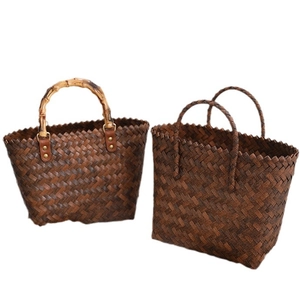 Handmade brown straw tote bags with bamboo handle and woven texture for summer beach