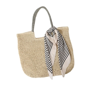 Large beige woven straw tote bag with black and white striped silk scarf decoration