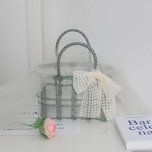 Green woven bridesmaid handbag with white lace bow and elegant pearl mesh details