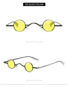 Detail view of small round punk sunglasses with black metal frame and yellow lenses