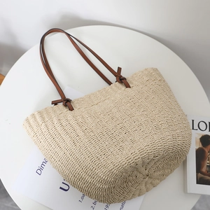Straw tote bag with brown leather straps and large capacity for summer beach trips